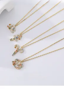 Macro shot of S925 silver zodiac pendants with colorful zircons on gold chains