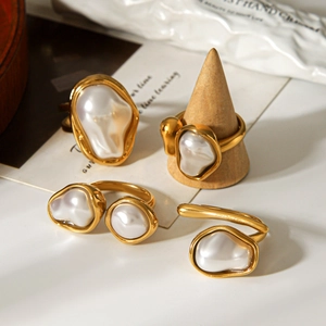 Baroque pearl rings set in vintage gold finish on wooden displays for women