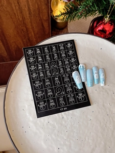 Detailed Christmas nail art stickers featuring white deer and snowman on wood background