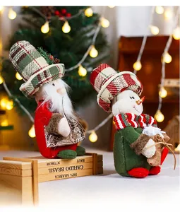 Close-up of plush Christmas dolls with vintage plaid hats and cozy knitted fabric textures