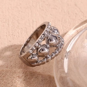 Macro shot of silver-tone ring featuring pavé crystals and polished spherical beads detail