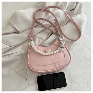 Pink heart-embossed crescent shoulder bag with elegant pearl strap and silver pendant