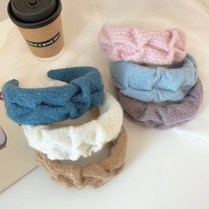 Set of five soft knitted twist headbands in pastel colors for a stylish voluminous hair look