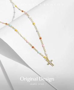 Detail of s925 silver gold cross necklace with colorful beads and zircon stones