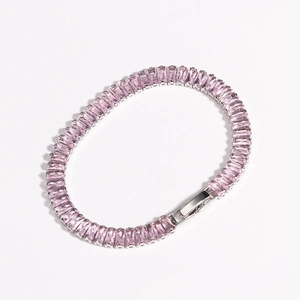 Detailed view of pink rectangular-cut zircon crystals on a silver-toned metal bracelet
