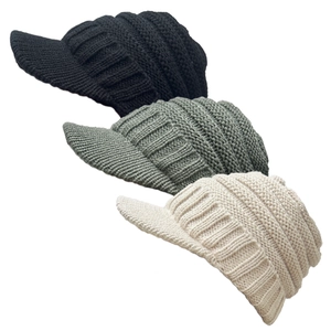 Detailed knit texture of three visor beanies in black, grey, and cream with short brims