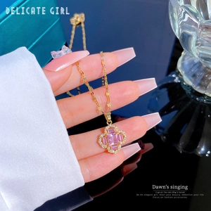 Elegant gold flower necklace with pink clover pendant and sparkling cubic zirconia