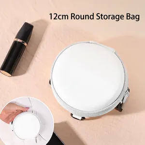 Detailed view of a 12cm white round PU leather case with silver zipper and hanging strap