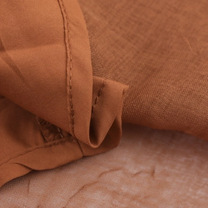 Brown V-neck maxi dress with ruched waist details and premium linen-like fabric texture
