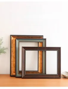 Detail of vintage photo frames with bead texture edges and antique wood finishes
