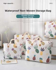 Detail of three non-woven storage bags with pineapple patterns and durable handles