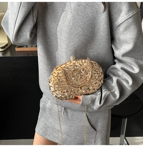 Detail of champagne gold sequin evening bag with rhinestone clasp and metal chain