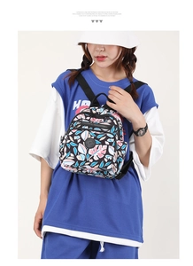 Mini nylon backpack with tropical leaf prints shown on model for size perspective