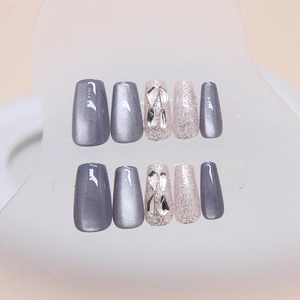 Blue cat eye press-on nails set with glitter and rhinestones in medium trapezoid shape
