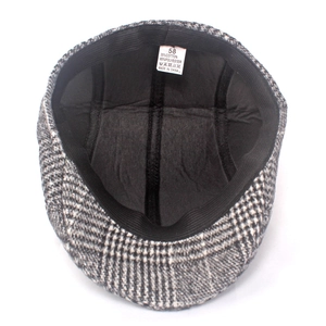 Detail of wool plaid flat cap interior showing 35% cotton lining and size 58 label