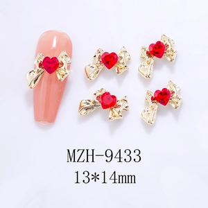 Detailed view of red heart bow nail charms with 13x14mm size marking on gold alloy base