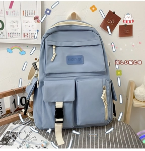 Detail of light blue multi-pocket student backpack with adjustable buckles and zippers