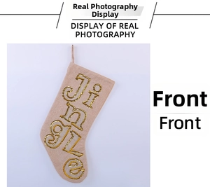 Detail of burlap Christmas stocking with gold sequins Jingle lettering and hanging loop