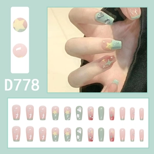 Star patterned gradient press-on nails in coffin shape with sparkling rhinestones and glitter