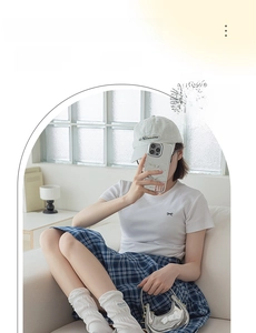 Detail of white cotton slouch socks with butterfly bow and letter embroidery in campus style