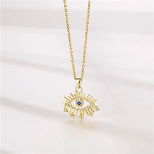 Golden Evil Eye necklace with blue stone and pavé zircons on a minimal background