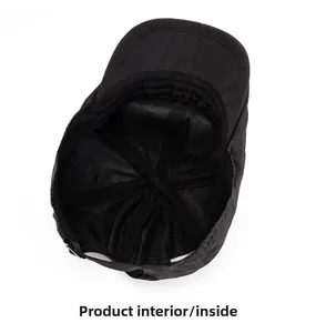 Detail view of the black quick-dry cap showing breathable mesh lining and reinforced seams