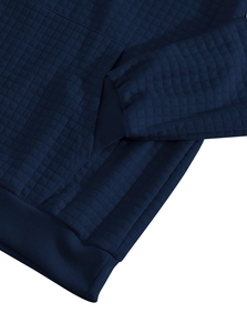 Detail of dark blue waffle textured fabric with ribbed cuff on a men's zip-up hoodie