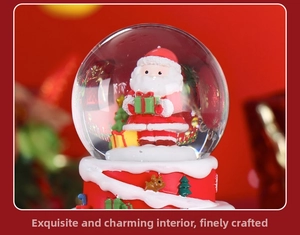 Close-up of a festive snow globe featuring Santa Claus with a reindeer base decoration