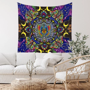 Detailed psychedelic mandala tapestry with butterfly and mushroom over a white sofa