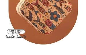 Close-up of portable jewelry box with leather handle and vintage floral fish pattern print