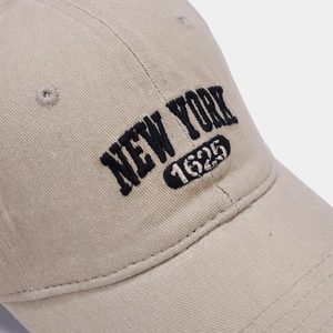 Close-up of black New York 1625 embroidery on khaki cotton baseball cap detail
