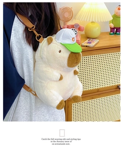 Detail of cute Capybara plush backpack with green cap shown in a cozy home setting