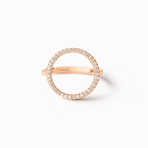 Macro shot of rose gold circle ring featuring pavé set cubic zirconia on white background
