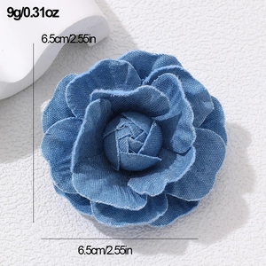Detailed view of handmade blue denim camellia flower brooch with 6.5cm size dimensions