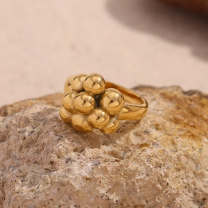 Macro shot of gold-plated balloon bubble ring on natural rock texture detail