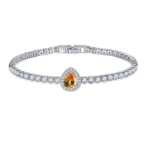 Close-up of amber yellow pear-cut halo crystal on a silver tennis bracelet with clasp