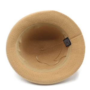 Detailed inner view of knit cloche hat showing material composition label and sweatband