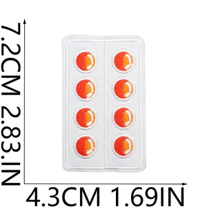 Detail of embroidered medical pill patch showing red circles with precise dimensions