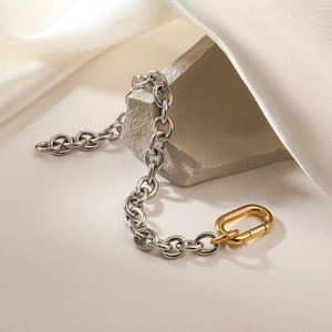 Two-tone 18K gold plated stainless steel chain bracelet on white silk and stone
