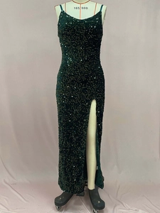 Détail d'une robe de soirée à paillettes vert foncé avec fente latérale chic
