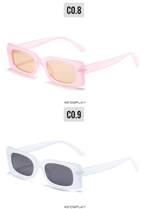 Detail of trendy rectangle sunglasses in pink and clear frames from 45-degree angle