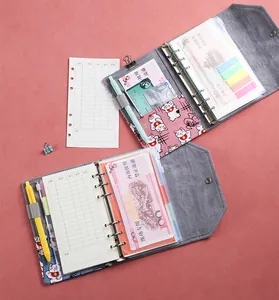 Close-up of 6-ring felt binder with budget sheets, card slots, and lucky cat motif