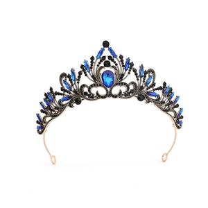Detailed view of Baroque gold crown with deep blue gems and black rhinestones