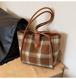 Brown plaid woolen tote bag with leather trim on stone base for autumn fashion