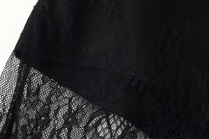 Close-up of exquisite black floral crochet lace fabric with sheer mesh texture