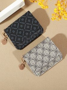 Top view of printed multi-functional card wallets in black and off-white with metal rings