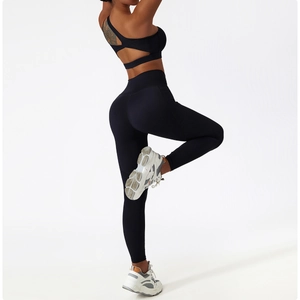 Close-up of cross-back yoga bra and high-waisted leggings with cutout detail in black