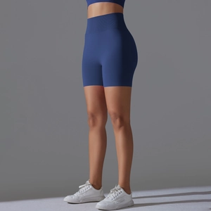 Detail of high waisted seamless dark blue yoga shorts showing body contouring fit