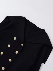 Detail of black knit cardigan featuring a sailor collar and embossed gold buttons