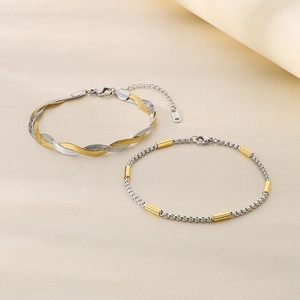 Detail of two-tone stainless steel snake and square box chains with gold accents